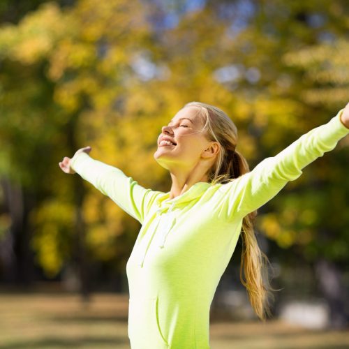 fitness and lifestyle concept - woman doing sports outdoors